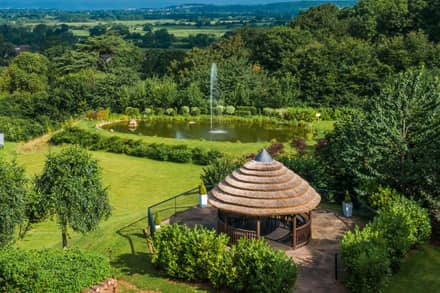 Outdoor space with lake and gazebo at Cadbury House