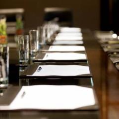 Boardroom layout with glasses and stationery. Photo