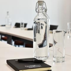 Meeting bottle of water with notebook and pen Photo