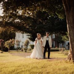 Bride and Groom walking in the Gosfield Hall grounds